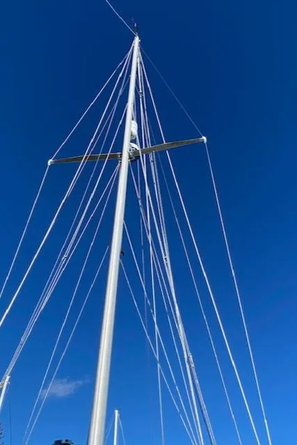 Slide: The Image of Tall mast of a 1986 Cape Dory 36 sailboat against a clear blue sky. - 10