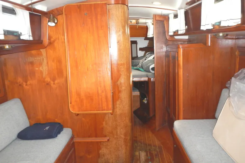 Slide: The Image of Interior of 1986 Cape Dory 36 sailboat with wooden paneling and seating. - 14