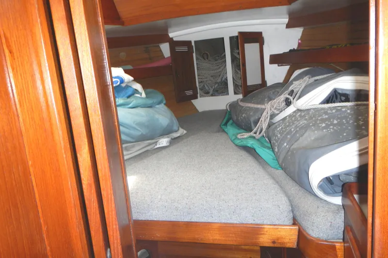 Slide: The Image of Cozy cabin interior of 1986 Cape Dory 36 sailboat with bedding and wooden finish. - 15