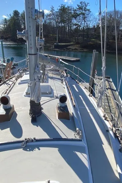 Slide: The Image of 1986 Cape Dory 36 sailboat docked by a serene waterfront. - 4