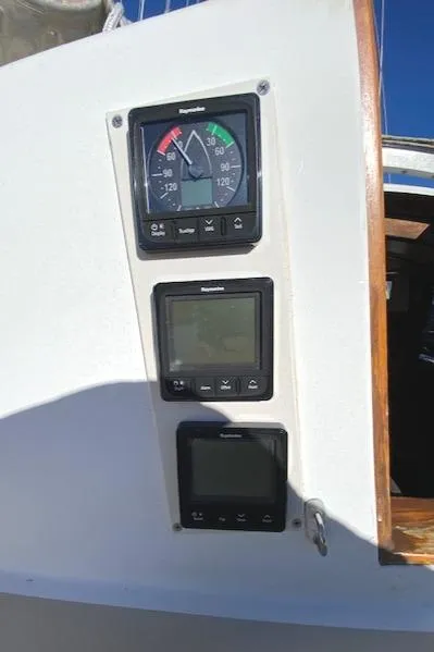 Slide: The Image of Cape Dory 36 sailboat, 1986 model, featuring navigational instruments on the control panel. - 6