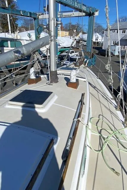 Slide: The Image of 1986 Cape Dory 36 sailboat deck with rigging and winches in a boatyard. - 9