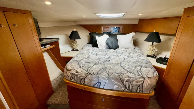 Slide: The Image of Luxurious cabin interior of 2000 Luhrs 36 Convertible yacht with cozy bedding. - 2