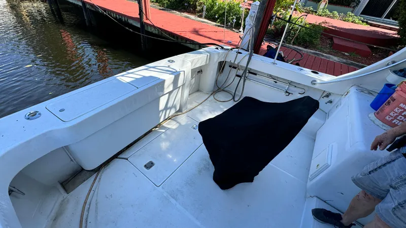 Slide: The Image of Luhrs 36 Convertible 2000 boat deck with covered equipment, dockside view. - 3