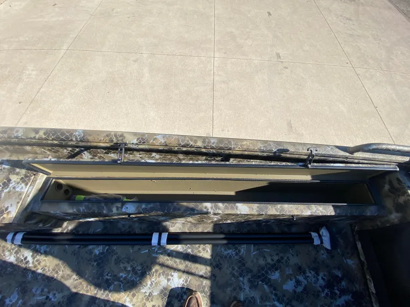 Slide: The Image of 2025 Excel 1854 F4 Shallow Water boat interior with storage compartment open. - 16