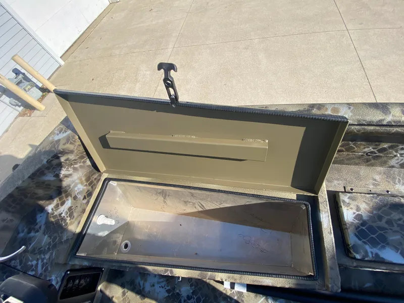 Slide: The Image of Open storage compartment on 2025 Excel 1854 F4 Shallow Water boat. - 21