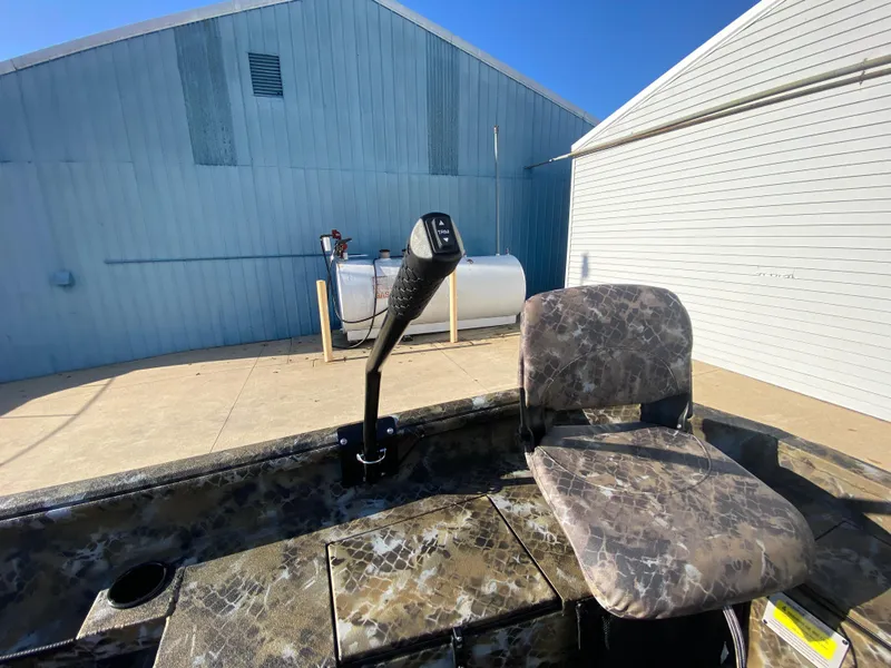 Slide: The Image of Excel 1854 F4 Shallow Water boat, 2025 model, with camo seat and control lever. - 30