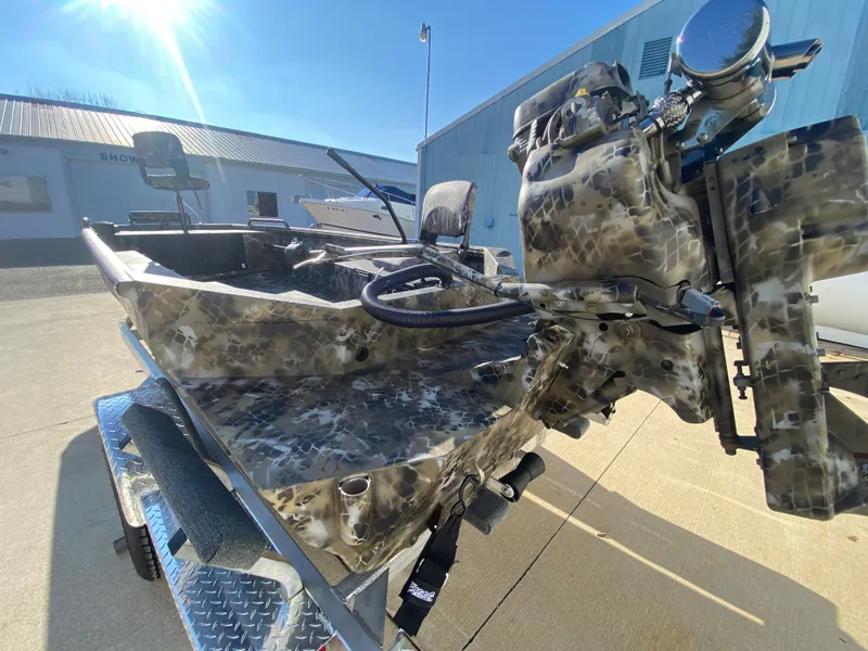 Slide: The Image of 2025 Excel 1854 F4 Shallow Water boat with camouflage design on a trailer. - 33