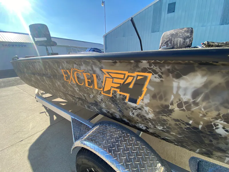 Slide: The Image of 2025 Excel 1854 F4 Shallow Water boat with camouflage design on a trailer. - 34