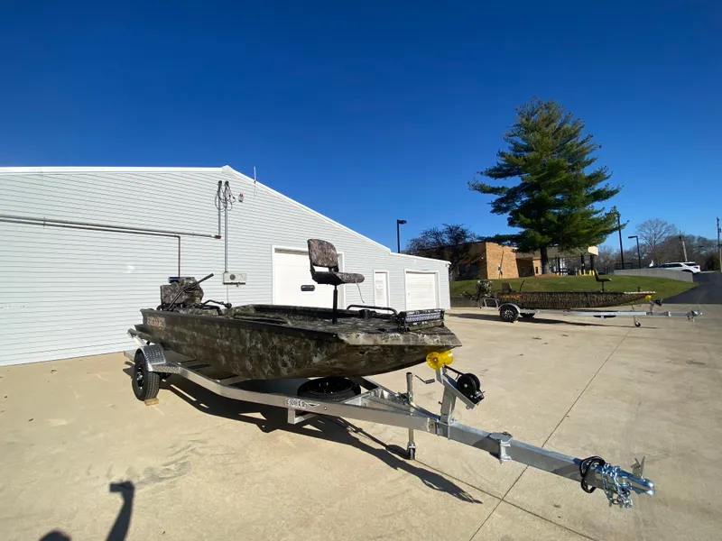 Slide: The Image of 2025 Excel 1854 F4 Shallow Water boat on trailer, parked outdoors. - 9