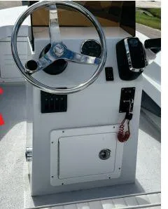 Slide: The Image of 2023 Ultra Lite Tenders 380 steering console with controls and storage compartment. - 4