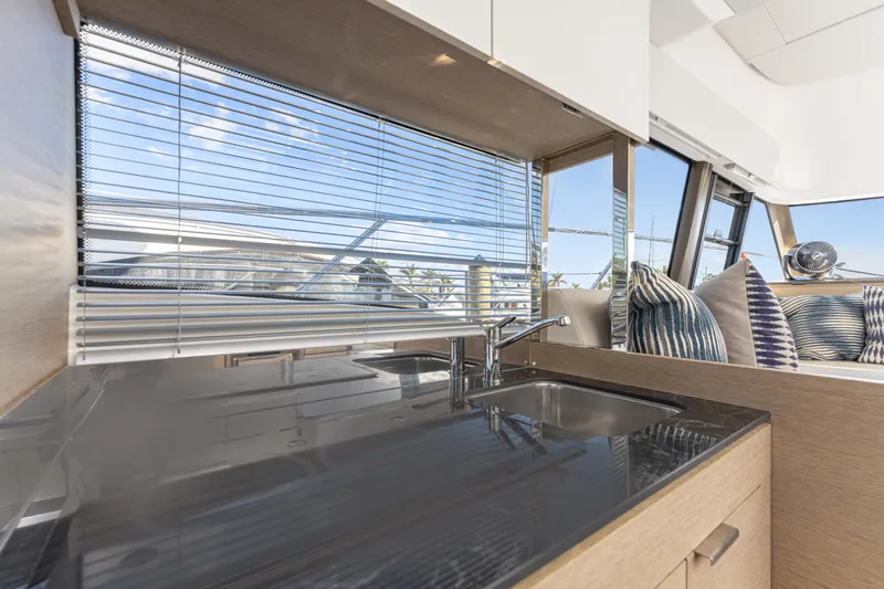 Slide: The Image of Interior of 2020 Prestige 420 Flybridge yacht with modern kitchen and window view. - 11