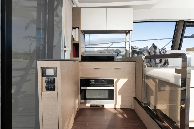 Slide: The Image of Modern kitchen interior on 2020 Prestige 420 Flybridge yacht, featuring sleek cabinetry and appliances. - 12
