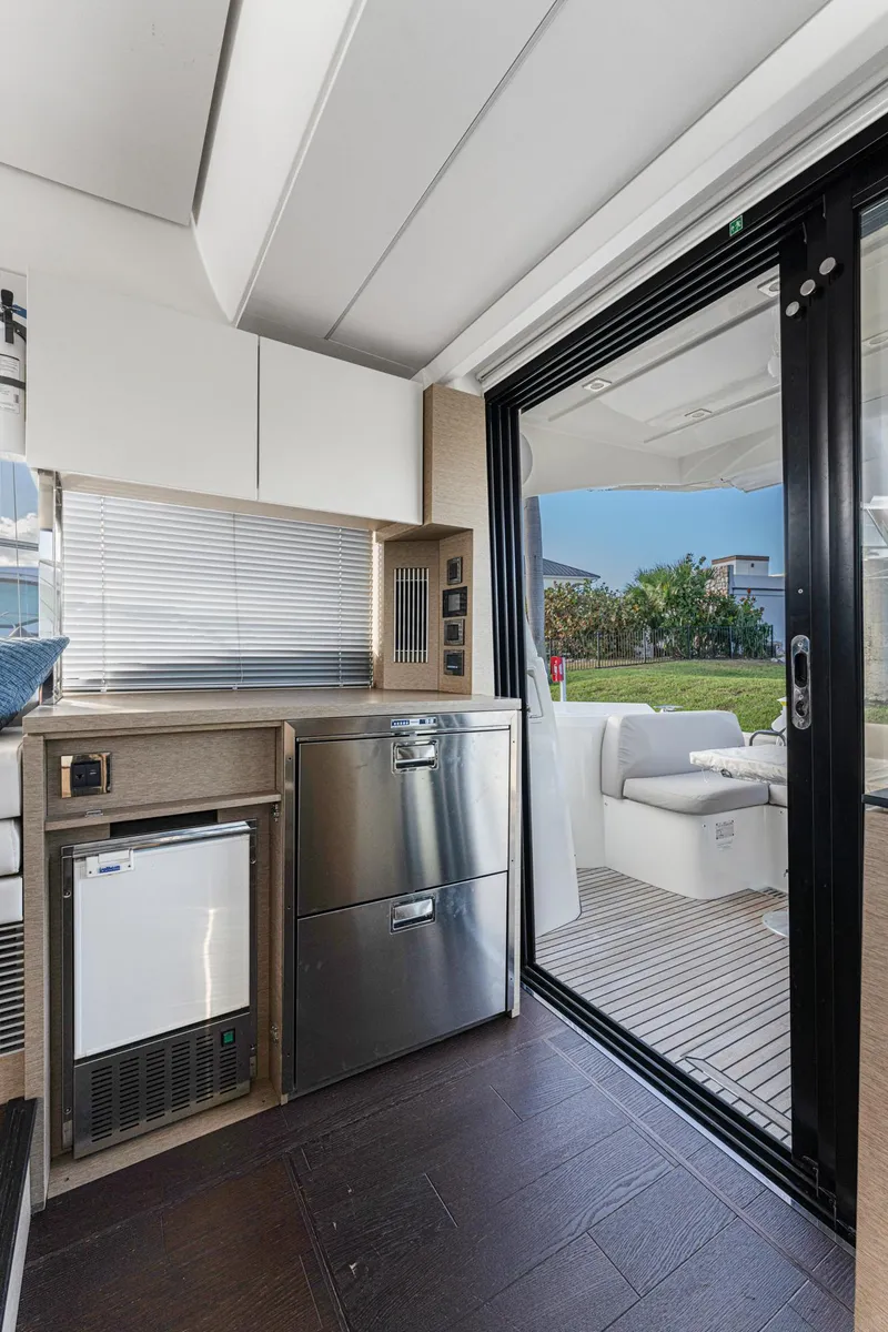 Slide: The Image of Interior of 2020 Prestige 420 Flybridge yacht with modern kitchen and outdoor seating area. - 42