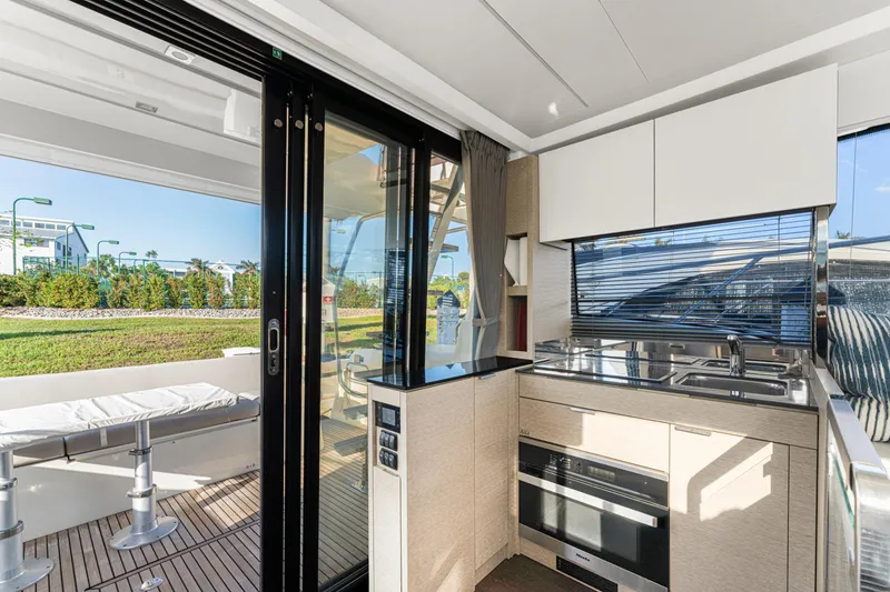 Slide: The Image of Modern kitchen on 2020 Prestige 420 Flybridge yacht with sleek design and outdoor view. - 44