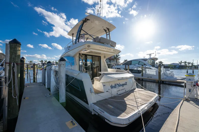 Slide: The Image of 2020 Prestige 420 Flybridge yacht docked at marina under sunny sky. - 6