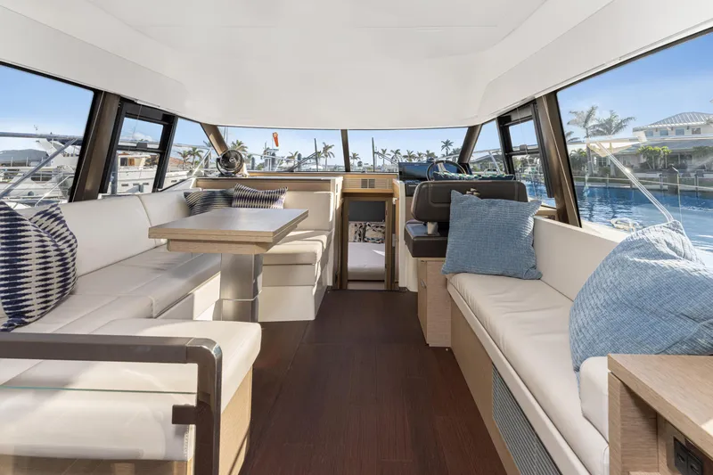 Slide: The Image of Luxurious interior of 2020 Prestige 420 Flybridge yacht with elegant seating and panoramic windows. - 9