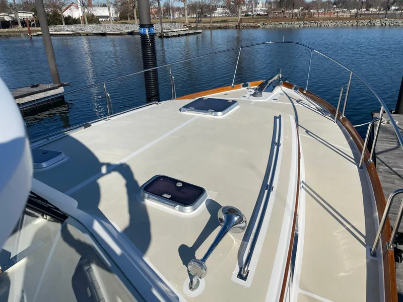 Slide: The Image of 2001 Grand Banks Eastbay 38 HX yacht docked at marina, showcasing sleek deck design. - 14