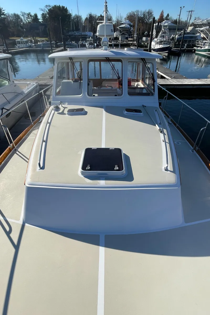 Slide: The Image of 2001 Grand Banks Eastbay 38 HX yacht docked at marina, showcasing radar and hatch. - 16