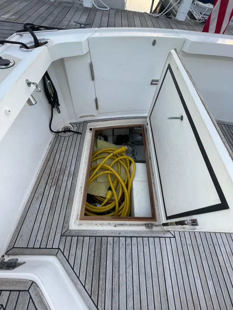 Slide: The Image of 2001 Grand Banks Eastbay 38 HX yacht deck with open hatch and wooden flooring. - 23
