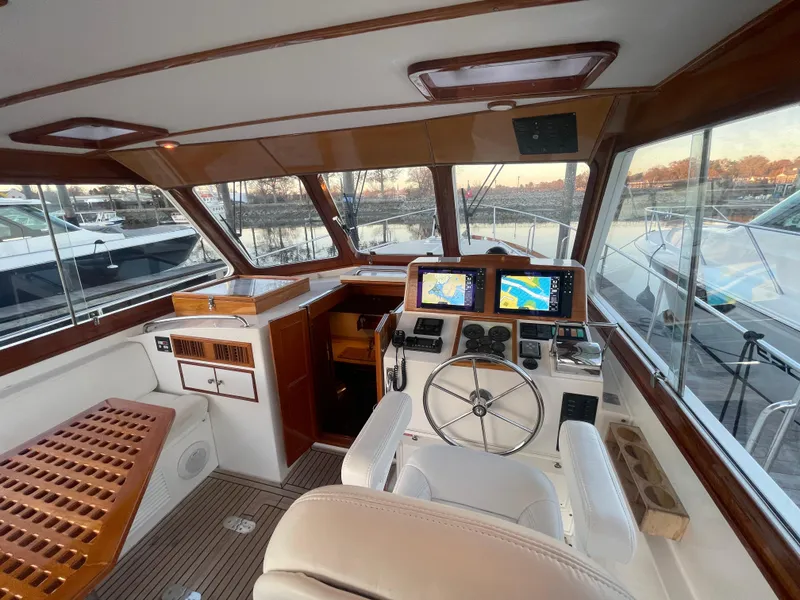 Slide: The Image of 2001 Grand Banks Eastbay 38 HX helm with wood accents and navigation displays. - 26