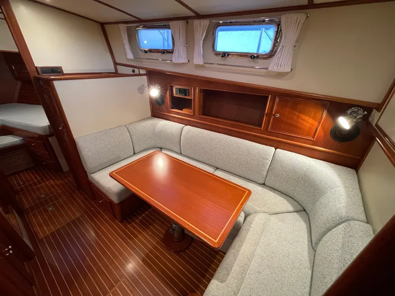 Slide: The Image of Interior view of 2001 Grand Banks Eastbay 38 HX yacht with wooden finish and large windows. - 32