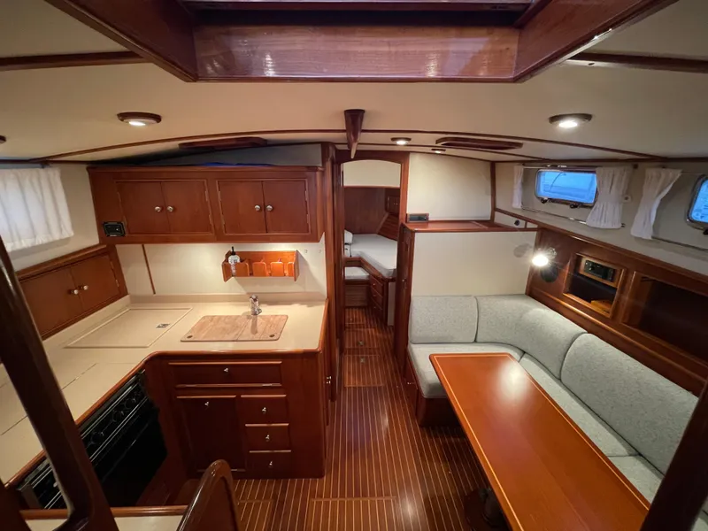 Slide: The Image of Interior of 2001 Grand Banks Eastbay 38 HX yacht with cozy seating and wooden finishes. - 34