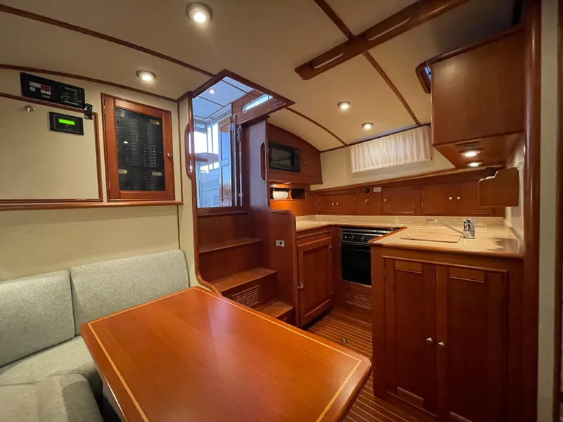 Slide: The Image of Interior of 2001 Grand Banks Eastbay 38 HX yacht with wood finish and cozy seating area. - 35