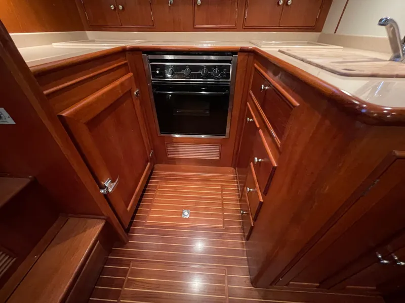 Slide: The Image of Luxurious 2001 Grand Banks Eastbay 38 HX yacht kitchen with wood cabinetry and modern appliances. - 39