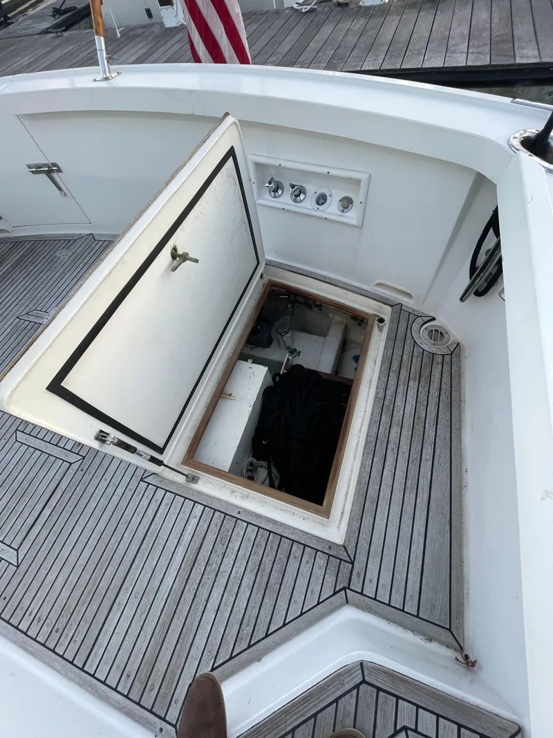 Slide: The Image of 2001 Grand Banks Eastbay 38 HX yacht deck with open hatch and wooden flooring. - 22