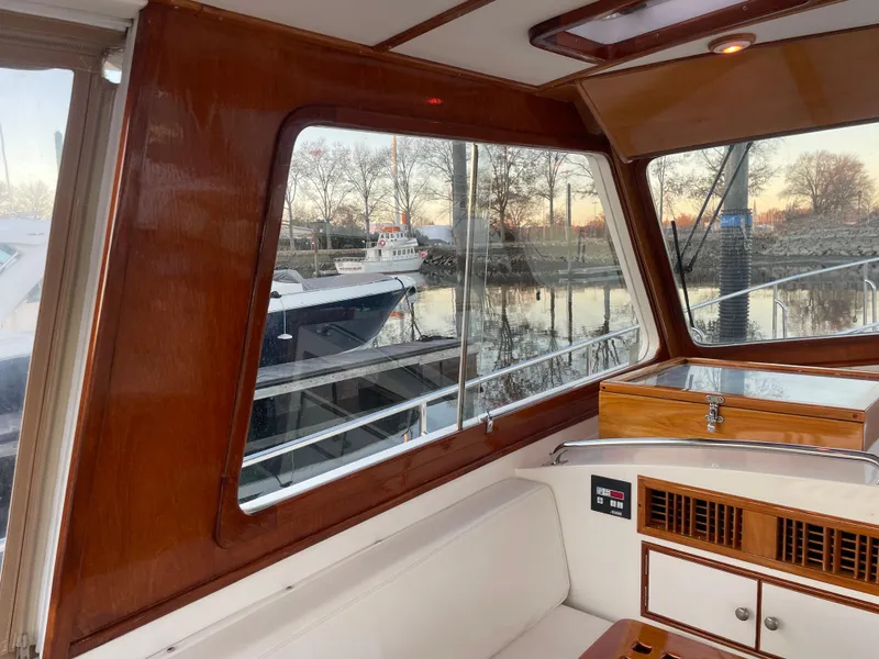 Slide: The Image of Interior view of 2001 Grand Banks Eastbay 38 HX yacht with wooden finish and large windows. - 31