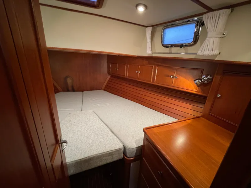 Slide: The Image of Cozy cabin interior of 2001 Grand Banks Eastbay 38 HX with wood finish and bed. - 41