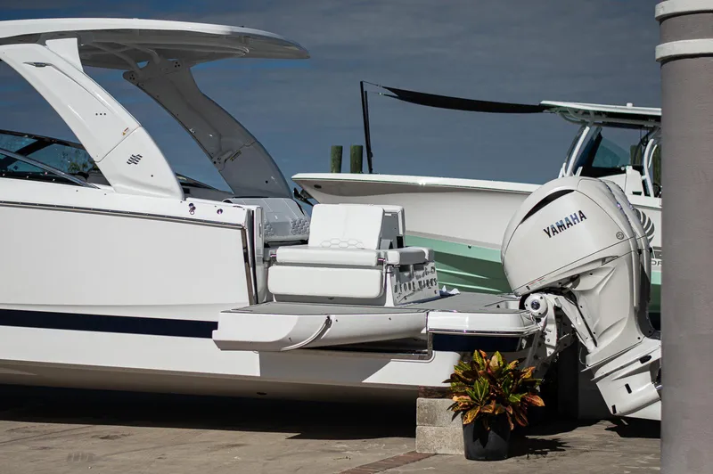 Slide: The Image of 2025 Four Winns H9 boat with Yamaha engine docked at marina. - 2