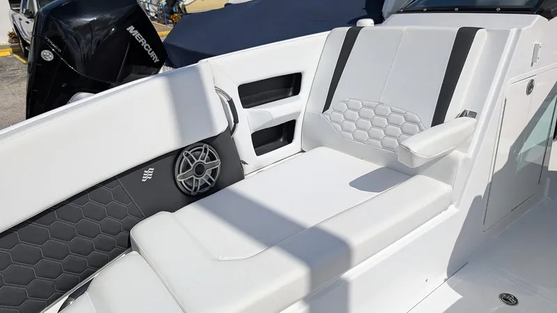 Slide: The Image of 2025 Four Winns H9 boat interior with white seating and speaker detail. - 22