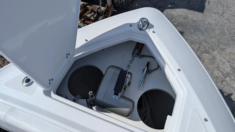 Slide: The Image of 2025 Four Winns H9 boat storage compartment with anchor and accessories. - 24