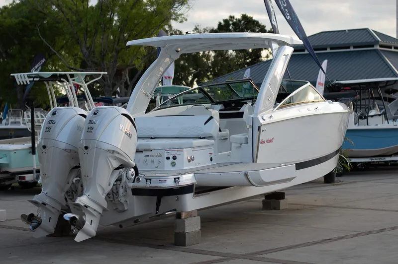 Slide: The Image of 2025 Four Winns H9 boat with dual engines displayed outdoors. - 3