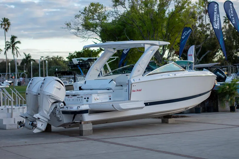 Slide: The Image of 2025 Four Winns H9 boat displayed outdoors with twin engines. - 4