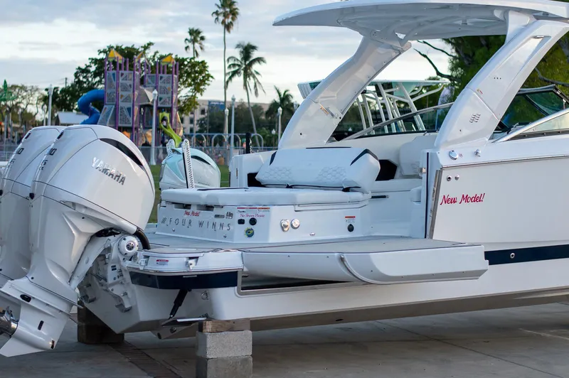 Slide: The Image of 2025 Four Winns H9 boat with Yamaha engine, docked outdoors. - 5