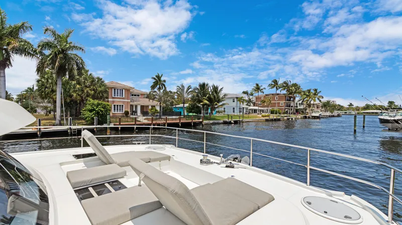 Slide: The Image of Fountaine Pajot MY 44 yacht, 2018 model, docked near waterfront homes and palm trees. - 10