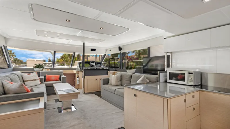 Slide: The Image of Luxurious interior of 2018 Fountaine Pajot MY 44 yacht with modern furnishings and panoramic windows. - 13