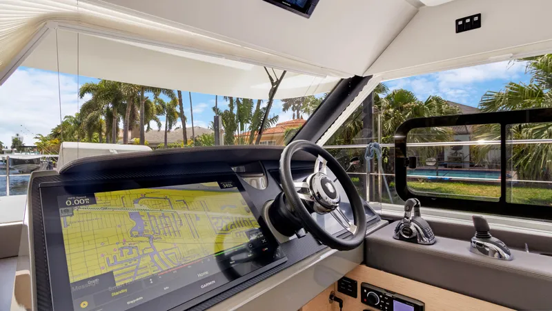 Slide: The Image of 2018 Fountaine Pajot MY 44 yacht helm with navigation display and steering wheel. - 23
