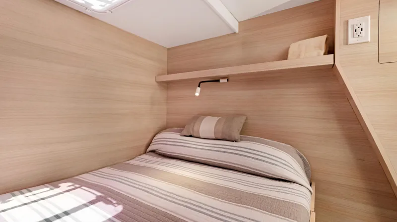 Slide: The Image of Cozy cabin interior of 2018 Fountaine Pajot MY 44 yacht with striped bedding. - 30