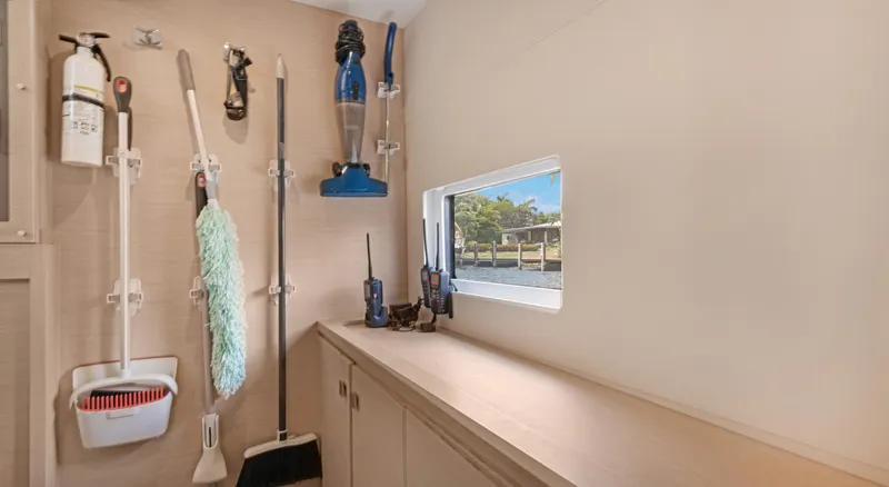 Slide: The Image of Utility room on 2018 Fountaine Pajot MY 44 yacht with cleaning tools and window view. - 42