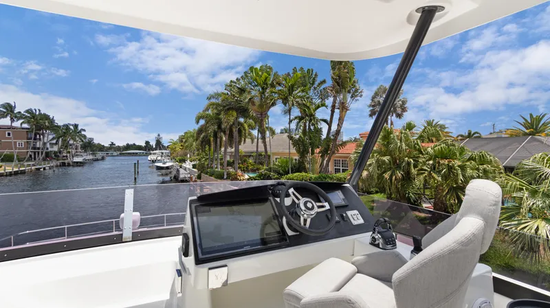 Slide: The Image of Fountaine Pajot MY 44 yacht helm with scenic waterfront view, 2018 model. - 45