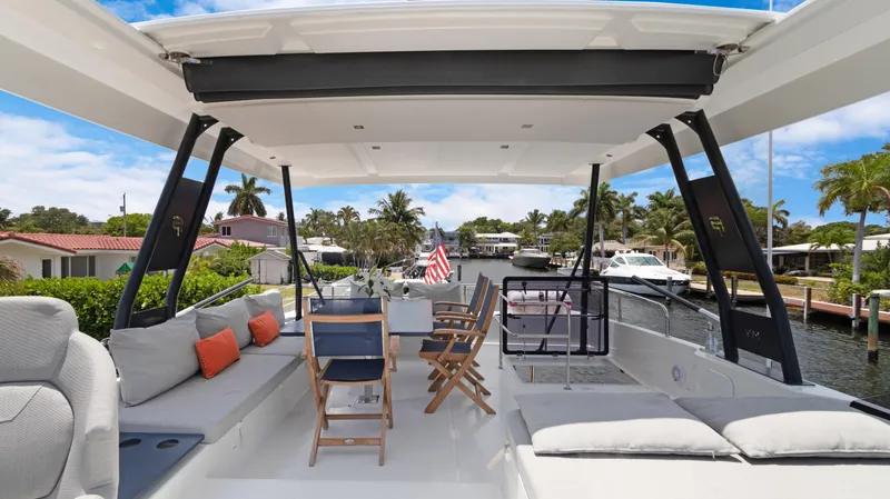 Slide: The Image of Luxurious 2018 Fountaine Pajot MY 44 yacht with spacious outdoor seating and scenic canal view. - 47