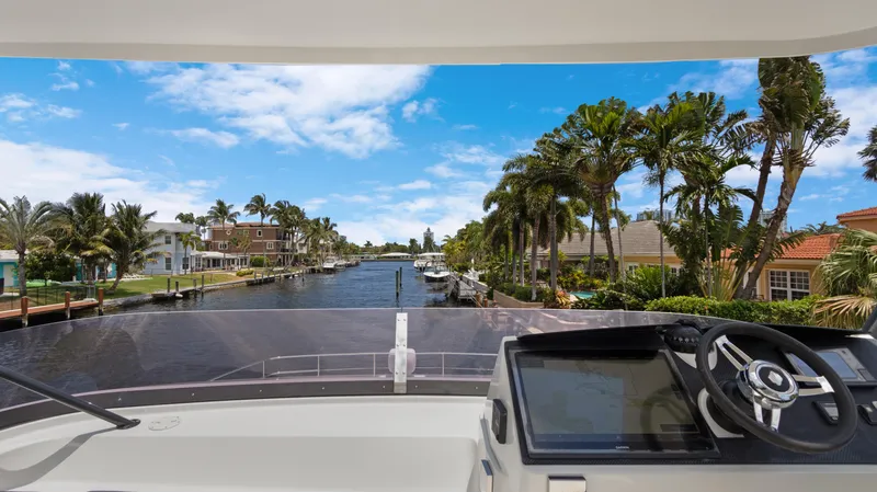 Slide: The Image of View from 2018 Fountaine Pajot MY 44 yacht, overlooking a scenic canal with palm trees. - 49