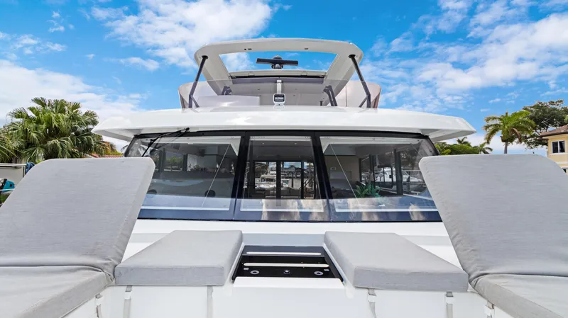 Slide: The Image of 2018 Fountaine Pajot MY 44 yacht with sun loungers, clear sky, and palm trees. - 8