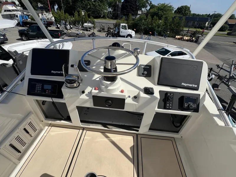 Slide: The Image of Helm of 1961 Bertram 31 Flybridge Cruiser with modern navigation equipment. - 13