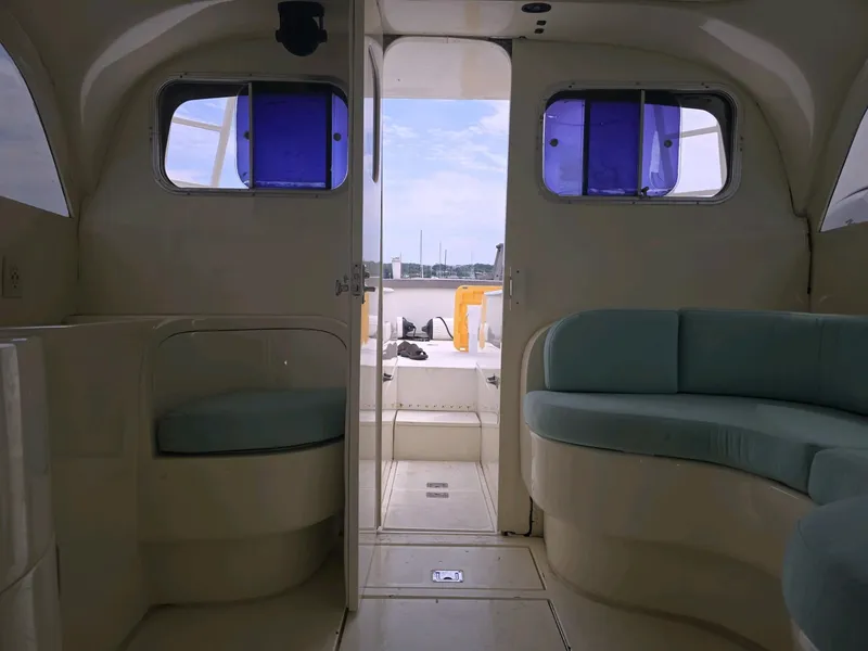 Slide: The Image of Interior of a 1961 Bertram 31 Flybridge Cruiser with blue cushioned seating. - 15