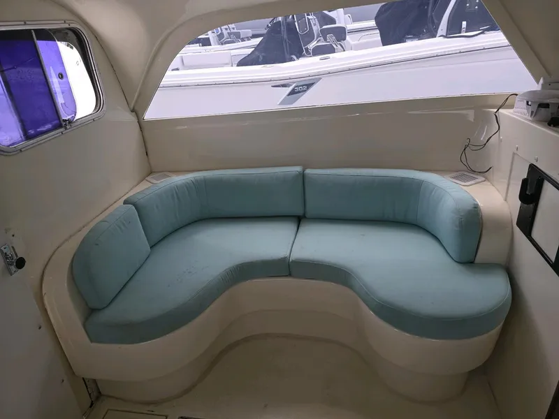 Slide: The Image of 1961 Bertram 31 Flybridge Cruiser interior with curved seating and light blue cushions. - 16
